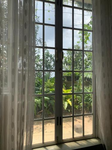 an open window looking out at a garden at Pekoetrails Hantana Homestay in Kandy