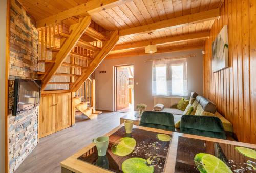 a living room with a couch and a table at Domki SUNSET Bałtycka in Dąbki