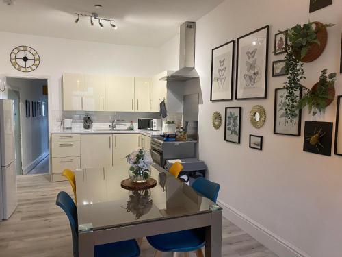 a kitchen and dining room with a table and chairs at The Retreats 1 Kenfig Hill Pet Friendly 2 Bedroom Flat with King Size bed twin beds and sofa bed sleeps up to 5 people in Kenfig Hill