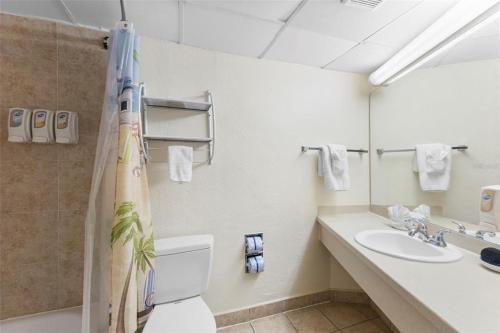 a bathroom with a toilet and a sink at Pelican Point on Clearwater Beach in Clearwater Beach