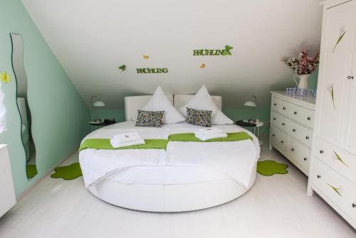 a bedroom with a large white bed in a room at Pension Traumfänger in Friedland