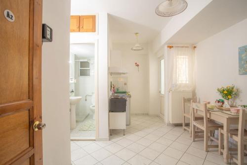 a kitchen and dining room with a table and a dining room at A2- Alexandri Apartment in Nydri