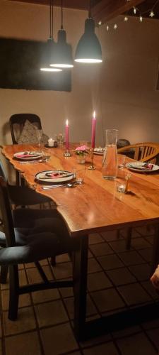 a wooden table with two candles on top of it at Schönes Haus in Tüttendorf