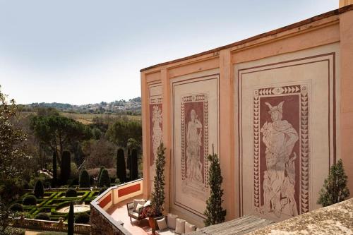 a building with paintings on the side of it at Casa Victor Riu in Piera
