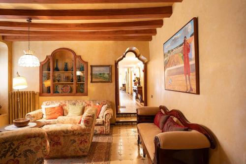 a living room with two couches and a table at Casa Victor Riu in Piera