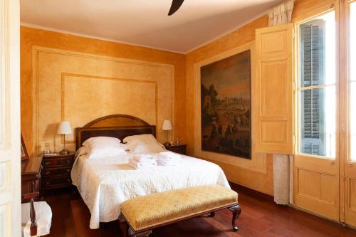 a bedroom with a bed and a painting on the wall at Casa Victor Riu in Piera