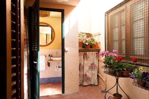 a bathroom with a sink and a mirror and flowers at Casa Victor Riu in Piera