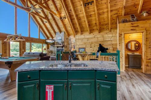 a kitchen with a green island in a log cabin at City View Chalet in Gatlinburg