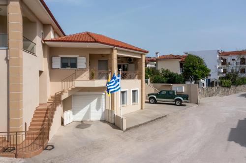 a house with a flag on the side of it at Lakis House Nikiti in Nikiti