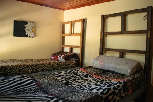 a bedroom with two bunk beds in a room at Acusi Hostel Camping in Humahuaca