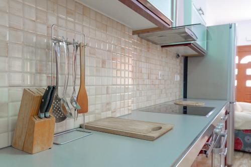 a kitchen with a blue counter top with utensils at Guest House Moonlight in Ksamil