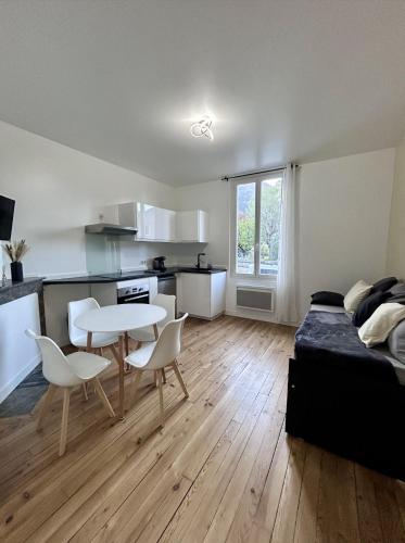 a bedroom with a bed and a table and chairs at T2 Pyrénéen in Pierrefitte-Nestalas