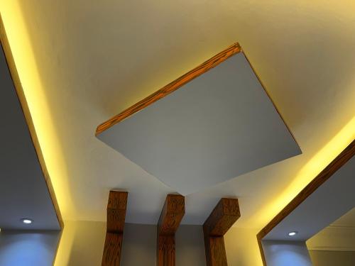 a large mirror on the ceiling of a room at CNJ’s Tranquil Haven in Kampala