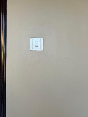 a lightswitch on a wall in a room at CNJ’s Tranquil Haven in Kampala