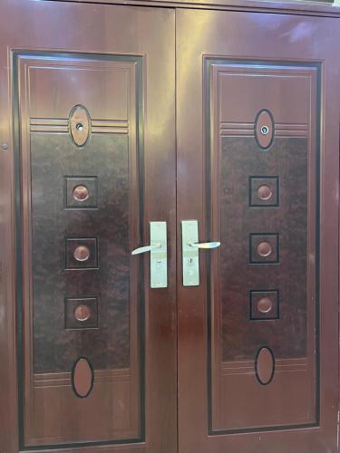 two wooden doors with numbers on them in a room at CNJ’s Tranquil Haven in Kampala