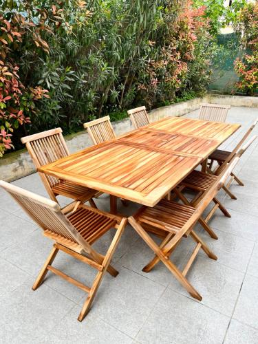 a wooden table with four chairs around it at Villa Victoria #8 persons #3 Bedrooms #Terrace # garage Beach - Calm and Clim in Roquebrune-Cap-Martin