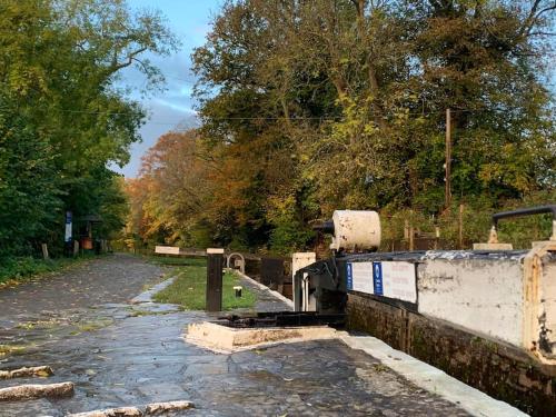a drained canal with trees on the side of a road at Mountain views in the heart of Brecon Town in Brecon