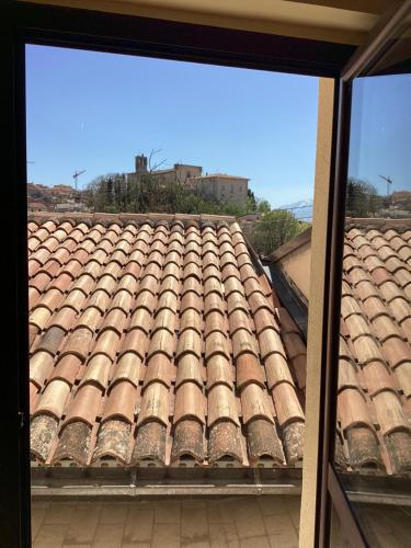 an view of a tile roof from a window at La casa di B in Paganica