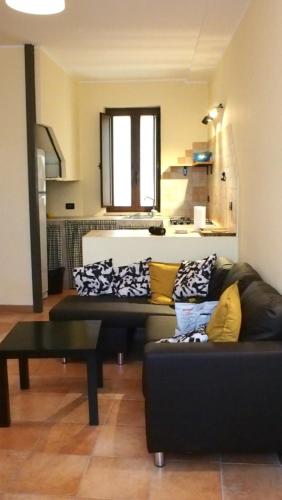 a living room with two couches and a table at La casa di B in Paganica