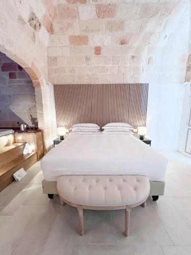 a bedroom with a large bed with a white bedvisor at DIMORA BIANCA in Triggianello