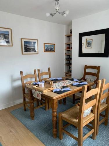 a dining room with a wooden table and chairs at Mountain views in the heart of Brecon Town in Brecon