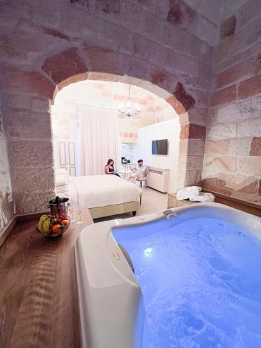 a large bathroom with a tub in a room at DIMORA BIANCA in Triggianello