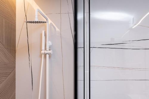 a glass door with a hanger on a wall at Ennea Muses Rooms and Suites in Nafplio