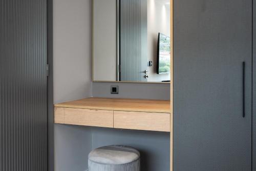a bathroom with a sink and a mirror at Ennea Muses Rooms and Suites in Nafplio