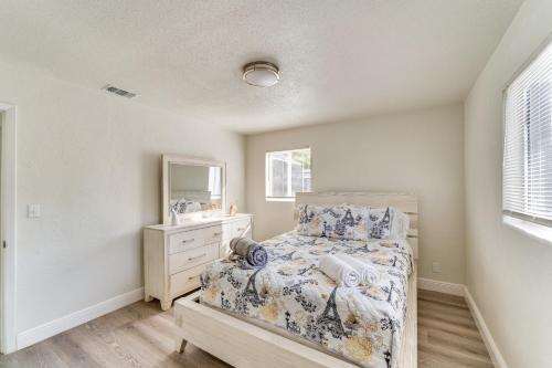 a bedroom with a bed and a sink and a mirror at Game Room, Private Pool South Daytona Home! in South Daytona