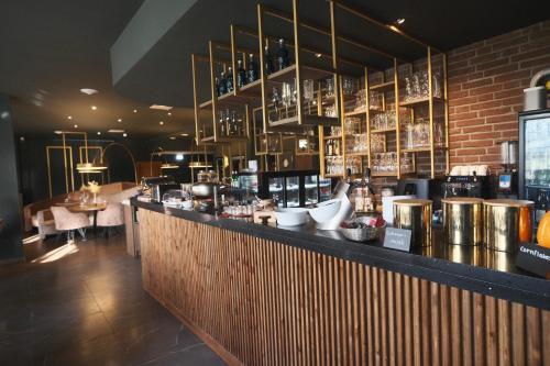 a bar in a restaurant with a brick wall at PARKHOTEL - Rosarium in Uetersen