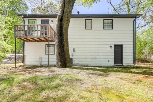 a house with a deck and a tree at Modern Conyers Retreat - 9 Mi to Arabia Mountain! in Conyers