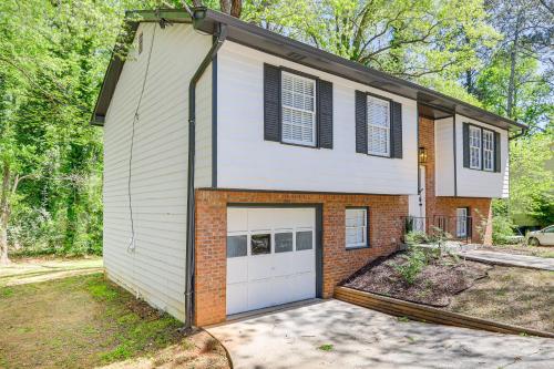 a house with a garage with at Modern Conyers Retreat - 9 Mi to Arabia Mountain! in Conyers