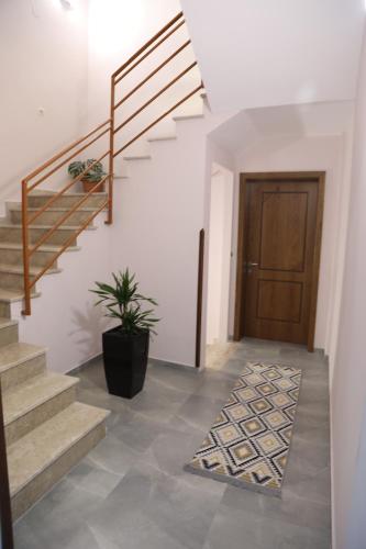 a hallway with stairs and a door with a potted plant at --HOTEL DEAL-- Rooms With Castle View in Krujë