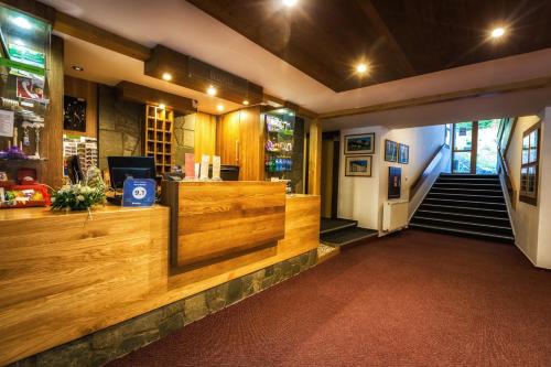 a lobby of a store with a counter and stairs at Hotel Malina-Ski Resort-SKI-IN & SKI-OUT in Ružomberok