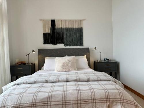 a bedroom with a large bed with two night stands at Seaside Oasis Oceanfront Bliss Condo at Semiahmoo in Blaine