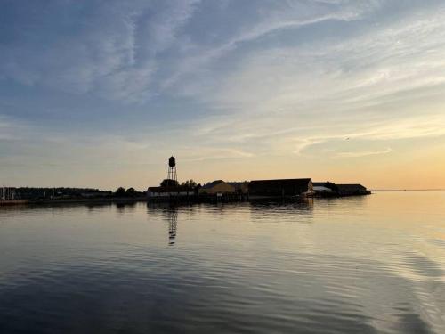 a large body of water with a water tower in the distance at Seaside Oasis Oceanfront Bliss Condo at Semiahmoo in Blaine