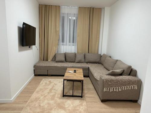 a living room with a couch and a table at Arasta Apartments in Skopje