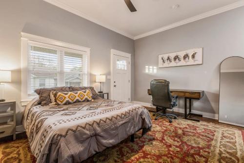 a bedroom with a bed and a desk and a chair at Highlands Home With Garage in Louisville