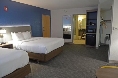 a hotel room with two beds and a bathroom at Comfort Suites Salem-Roanoke I-81 in Salem