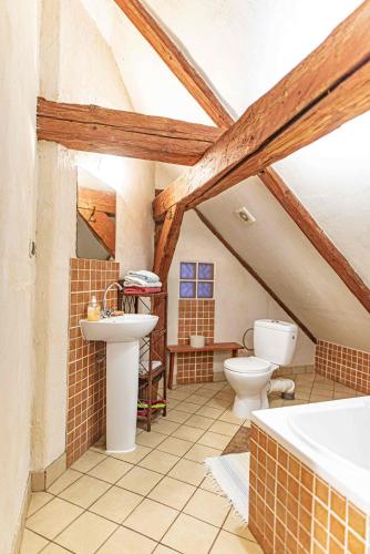 a bathroom with a sink and a toilet and a tub at Folwark Malinowy Chruśniak in Bisztynek