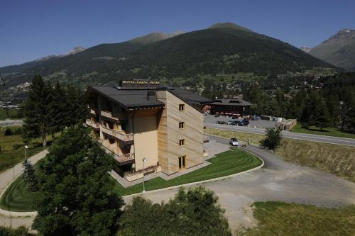 an aerial view of a building with mountains in the background at Hotel Garni Pegrà in Ponte di Legno