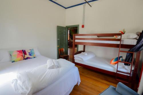 a room with two beds and a bunk bed at Michie Hostel in Providence