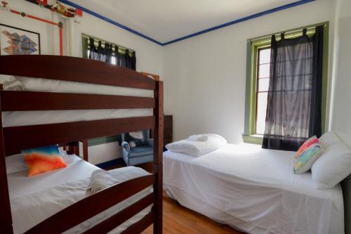 a bedroom with two bunk beds and a window at Michie Hostel in Providence