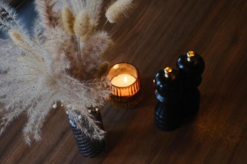 a candle and a vase on a table at PARKHOTEL - Rosarium in Uetersen