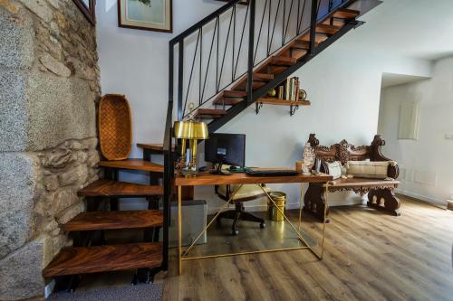 a home office with a desk and a staircase at Casa Lela Dumbria in Dumbría