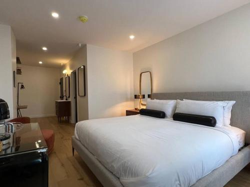 a bedroom with a large white bed in a room at The Phenix, Historic DTWN Hotel, Market Square View, King Bed, Room # 400 in Bangor