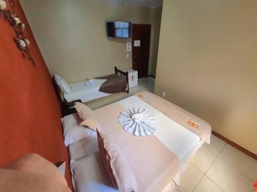 a hospital room with two beds and a table at Pousada Tuiuiu in Angra dos Reis