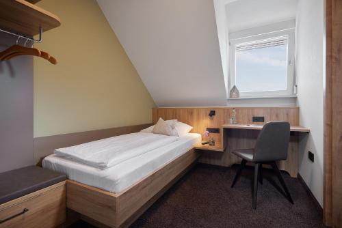 En eller flere senge i et værelse på Gasthaus Blume