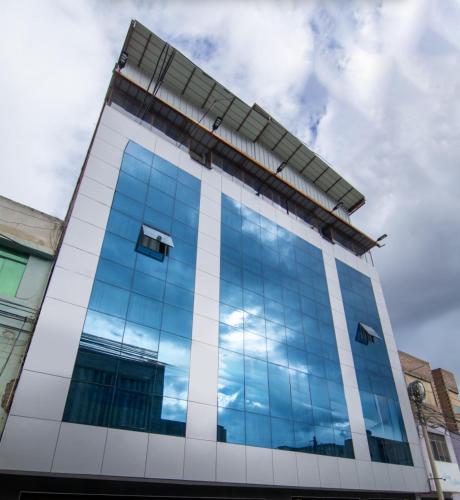 an office building with blue glass windows at Hotel Kapadokya in Huánuco