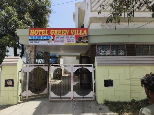 a hotel green villa with a sign above a gate at HOTEL GREEN villa in Rewa